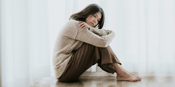 Lonely lady in brown sweater in addiction recovery