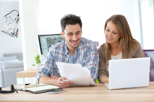 man and woman discussing some paperworks