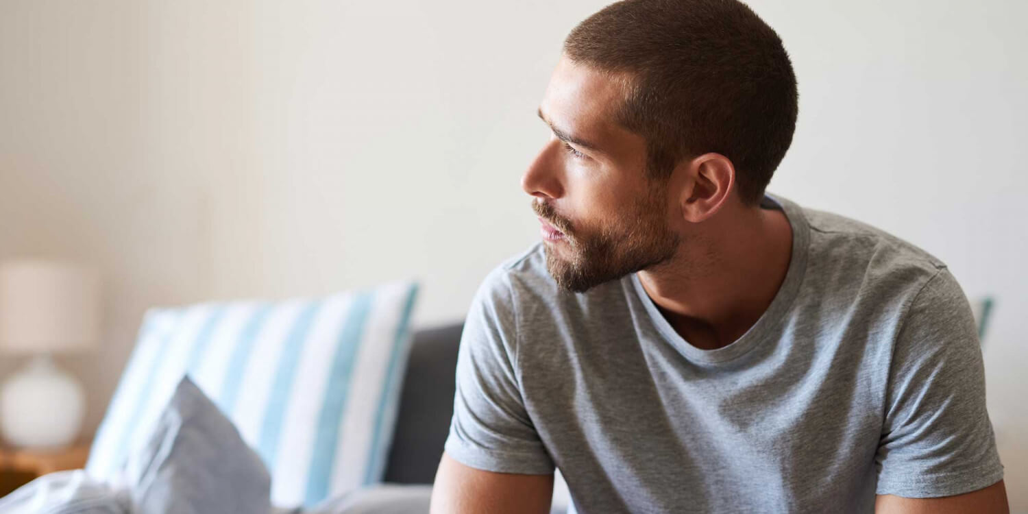 Man looking outside thinking about heroin abuse treatment at Roots