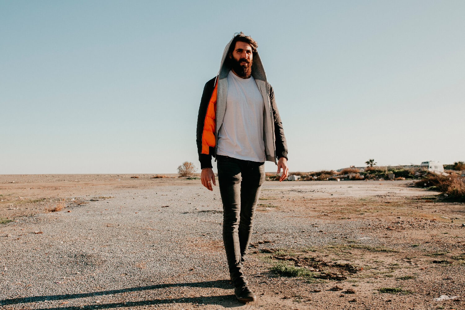 Man walking outside alone through a desert community