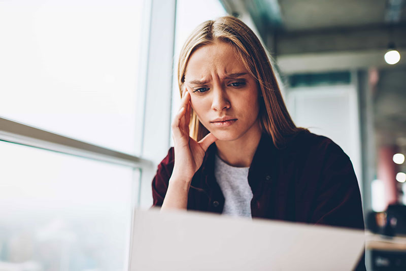 Woman with hand on her head suffering from stress