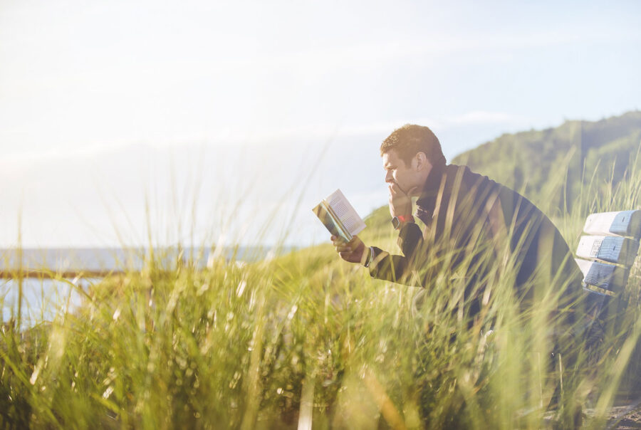 Man reading a book outdoor at Roots Recovery